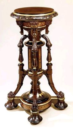 an ornately decorated wooden table with gold trimmings on the top and bottom