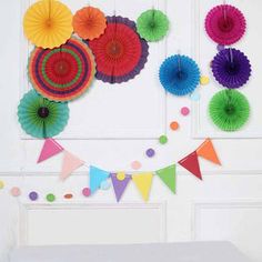 colorful paper fans hanging on the wall