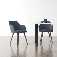 two chairs sitting at a table in front of a white wall