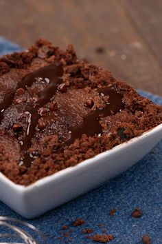 a square white dish filled with chocolate cake