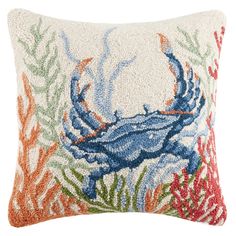 a blue crab on corals and seaweed is featured in this decorative throw pillow