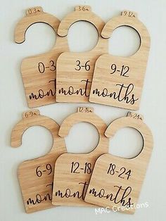 six wooden baby door hangers with numbers and date for each child's birth