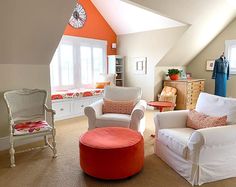 a living room filled with furniture and a clock mounted to the wall above it's windows