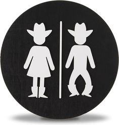 a black and white photo of a man and woman in cowboy hats standing next to each other