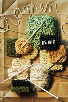 yarn and knitting needles on top of a piece of brown paper with the word free mix written across it