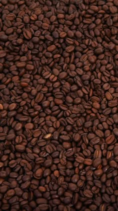 a pile of coffee beans sitting on top of each other