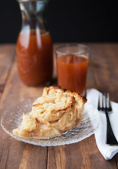 a piece of bread sitting on top of a glass plate next to a bottle of orange juice