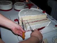 a person cutting a cake with a knife