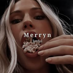 a woman eating popcorn with the words merryn joyful in front of her mouth