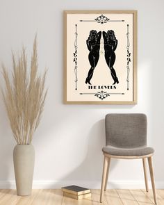 two women kissing in front of a framed art print on the wall above a chair