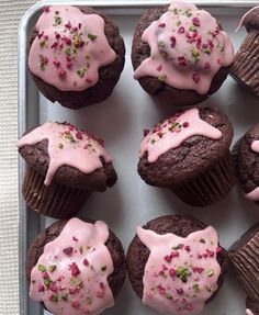 chocolate cupcakes with pink frosting and sprinkles