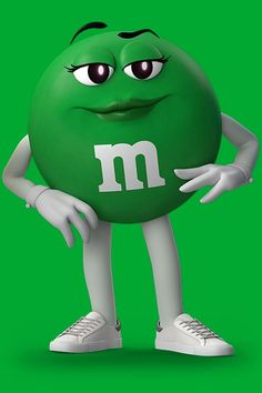 a green ball with the letter m on it's face and hands behind his head