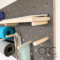 a wall mounted rack with yoga mats and other items