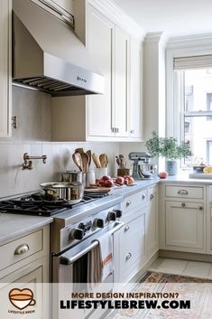 a kitchen with white cabinets and stainless steel stove top oven next to an open window