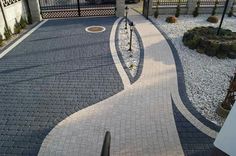 the walkway is lined with stones and gravel, leading to a gated in area