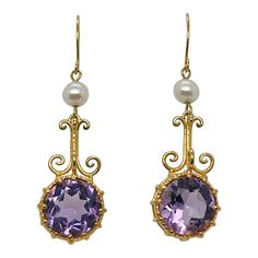 A very fine pair of earrings from the Metropolitan Museum of Art.  In satin finished 14k yellow gold .   Each earring prong set with a round faceted amethyst gemstone suspened below around white pearl and ear hook.  The gold has a satin finish beautifully highlights the purple in the amethyst.  Simply a wonderful Etruscan Revival style pair of earrings!   Date: 20th Century  Overall Condition: It is in overall good, as-pictured, used estate condition with some fine & light surface scratches and Amethyst Earrings Fine Jewelry For Formal Occasions, Formal Amethyst Drop Earrings, Elegant Purple 14k Gold Earrings, Yellow Gold Amethyst Earrings Hallmarked, Cabin Door, Princess Jewelry, Jewelry Illustration, Royal Dresses, Ocean Jewelry