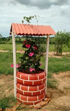 a red brick structure with flowers growing out of it's sides in the dirt