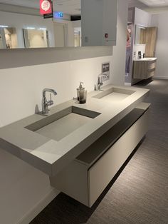 a modern bathroom with two sinks and mirrors on the wall above them is shown in this image