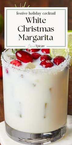 a white christmas margarita with lime and cherries