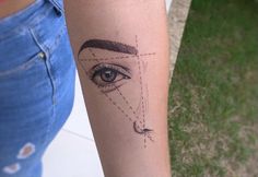 a woman's arm with a tattoo on it and an eye in the center