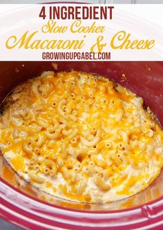 a red crock pot filled with macaroni and cheese