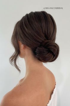 a woman with her hair in a low bun