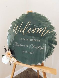 a welcome sign on top of a easel