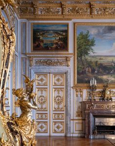 an ornate room with paintings on the wall