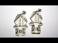 two origami birds sitting on top of each other made out of dollar bills