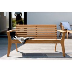 a wooden bench sitting on top of a hard wood floor