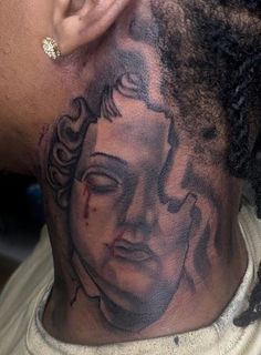 a man with a tattoo on his neck