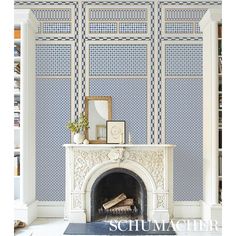 a fireplace in a room with blue and white wallpaper