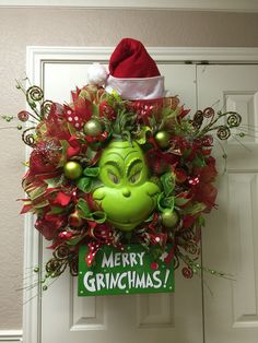 the grinch wreath is hanging on the front door