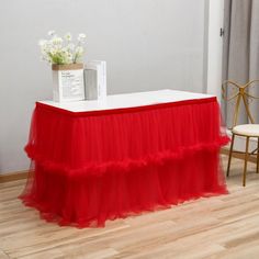 a table with a red skirt on it