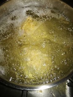 a pan filled with food cooking on top of a stove