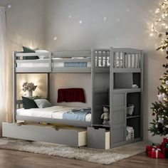 a bedroom with bunk beds and a christmas tree in the corner next to it,