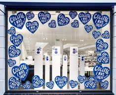 a store window with blue and white hearts on it