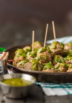 meatballs and broccoli on skewers in a bowl