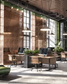 an office with lots of desks and plants in the center, along with hanging lights