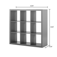 a white bookcase with six shelves and measurements for each shelf in the same room