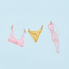 three bikinis hanging on a clothes line against a blue sky