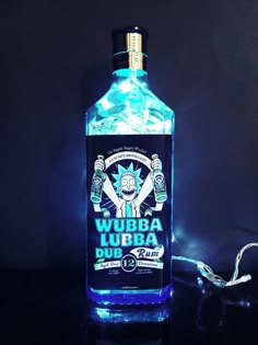 a lit up bottle sitting on top of a table