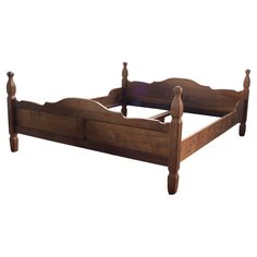 a wooden bed frame with two posts and no headboard or foot board is shown