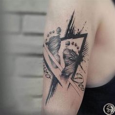 a woman's arm with a black and white tattoo design on her left shoulder