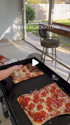 two homemade pizzas being cooked on an outdoor grill with the words, pizza on the blackstone