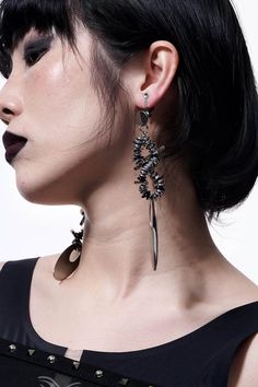 Embrace the perfect fusion of futuristic and punk aesthetics with our Mechanical Punk Metal Earrings / Ear Clips. These striking accessories feature a design composed of multiple spiral metal coils and irregular metal pieces, resembling a spiral galaxy. The bottom of each earring is adorned with a large oval metal plate, adding a bold and edgy element to the overall look. Crafted from premium materials, these earrings ensure durability and a distinctive style statement. Perfect fusion of futuris Black Metal Earrings For Alternative Fashion, Edgy Metal Plug Earrings, Punk Metal Earrings For Concerts, Punk Style Metal Earrings For Concert, Gothic Metal Earrings For Alternative Fashion, Edgy Metal Earrings For Party, Modern Internally Threaded Metal Plug Earrings, Edgy Metal Party Earrings, Edgy Metal Plug Earrings, Single Piece