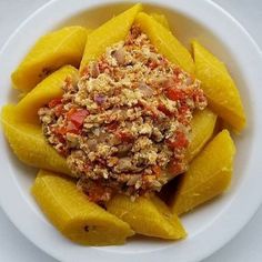 a white plate topped with pasta covered in toppings