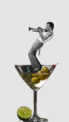 an image of a man playing the trumpet in a martini glass filled with olives