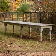 an old wooden bench sitting in the grass