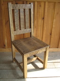 a wooden chair sitting on top of a hard wood floor next to a wooden wall